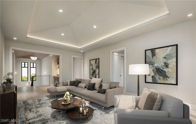 living room with recessed lighting, a raised ceiling, lofted ceiling, and wood finished floors