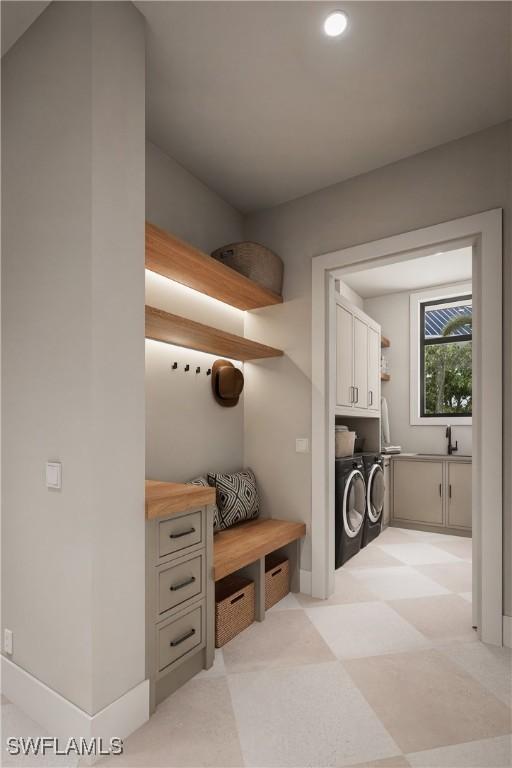 mudroom featuring a sink, light floors, recessed lighting, and washer and clothes dryer