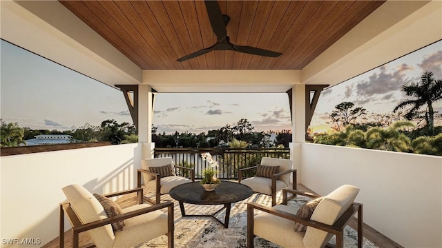 patio terrace at dusk featuring a ceiling fan