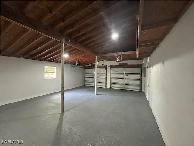 garage featuring a garage door opener and baseboards