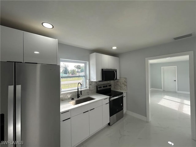 kitchen featuring a sink, visible vents, marble finish floor, appliances with stainless steel finishes, and decorative backsplash