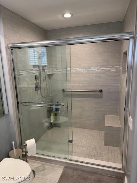 full bathroom with toilet and a shower stall