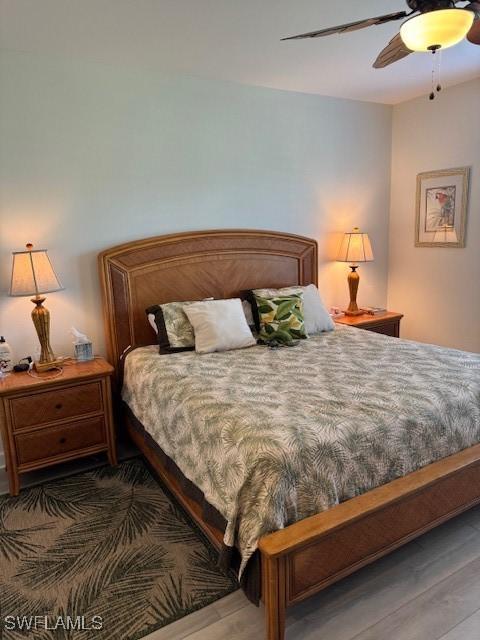 bedroom with a ceiling fan and wood finished floors