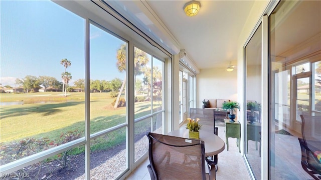 sunroom / solarium with a ceiling fan