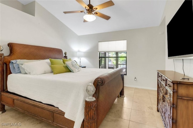 bedroom with vaulted ceiling, light tile patterned floors, a ceiling fan, and baseboards