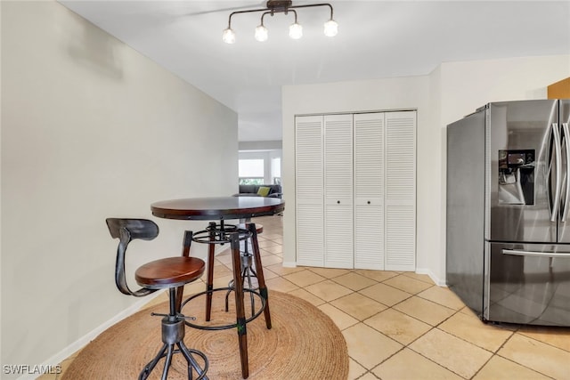 dining area with baseboards and light tile patterned floors