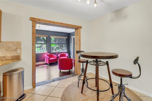 dining room featuring light tile patterned floors and baseboards