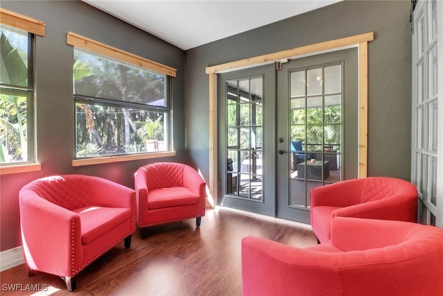 interior space with french doors, wood finished floors, and baseboards