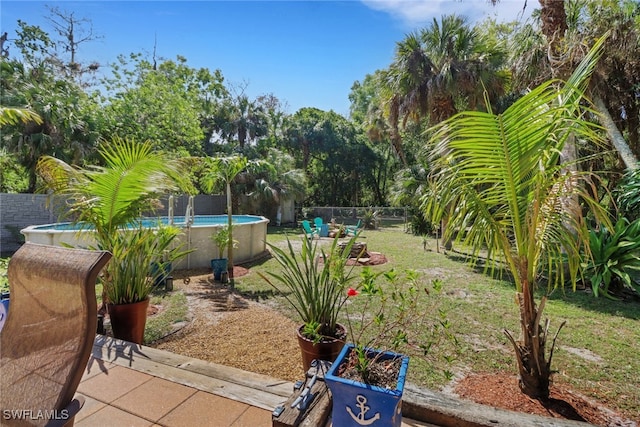 view of yard with a fenced in pool and a fenced backyard