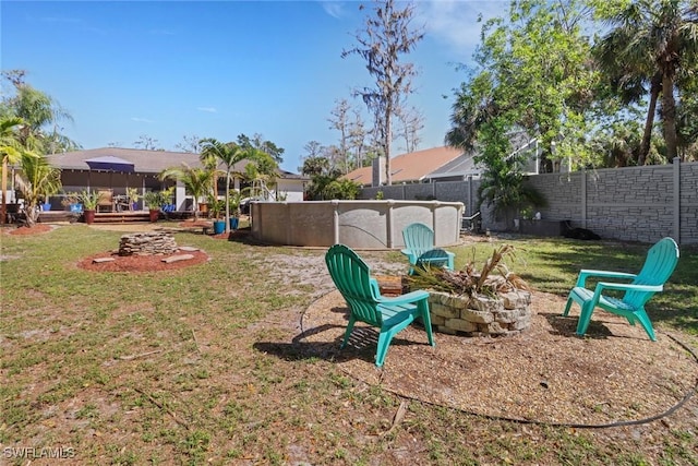 view of yard with a fenced in pool, a fenced backyard, and a fire pit