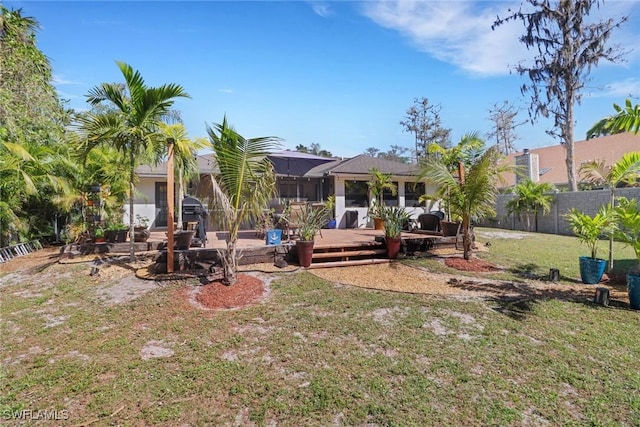 view of yard featuring a lanai and fence