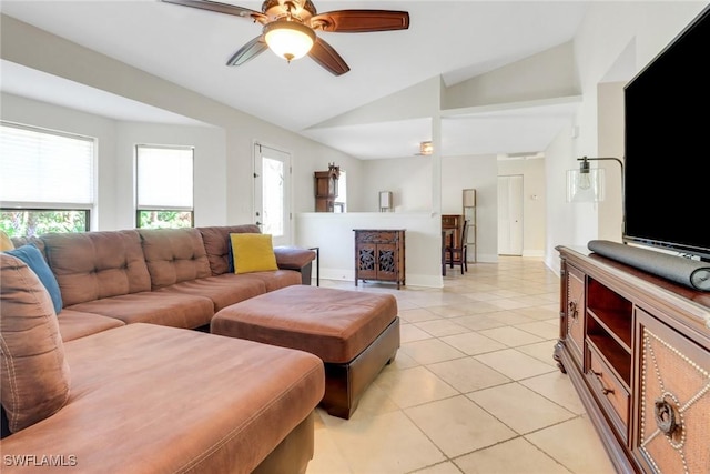 living area with a ceiling fan, lofted ceiling, light tile patterned flooring, and baseboards