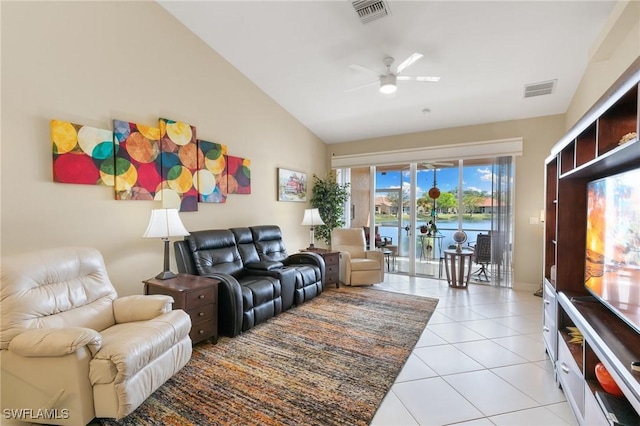 living room featuring lofted ceiling, light tile patterned floors, visible vents, and a ceiling fan