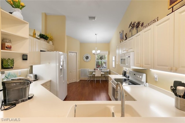 kitchen with visible vents, white appliances, dark wood-type flooring, a chandelier, and high vaulted ceiling