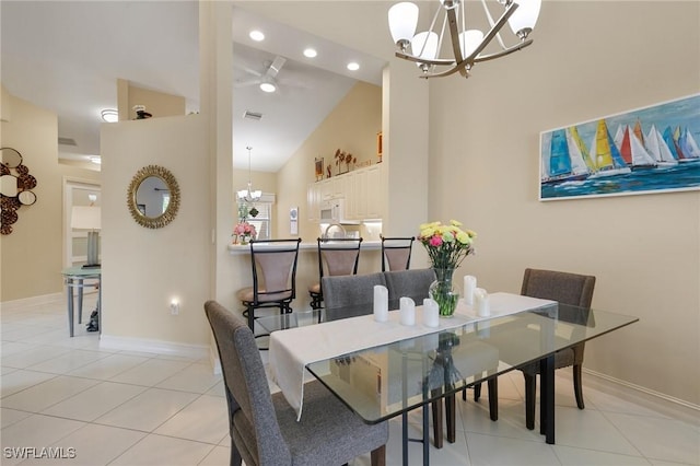 dining space with visible vents, baseboards, high vaulted ceiling, and light tile patterned floors