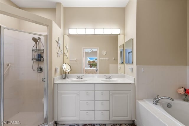 bathroom with a sink, a shower stall, and a bath