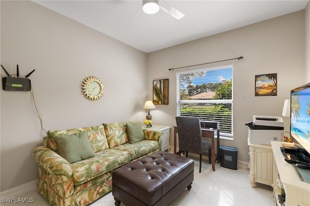 living room featuring baseboards and a ceiling fan