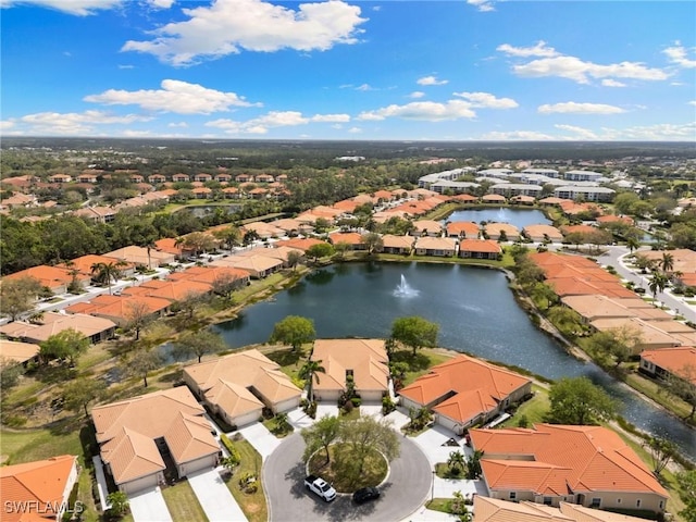 drone / aerial view with a residential view and a water view