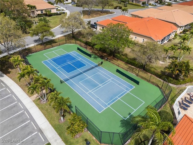 view of sport court featuring fence