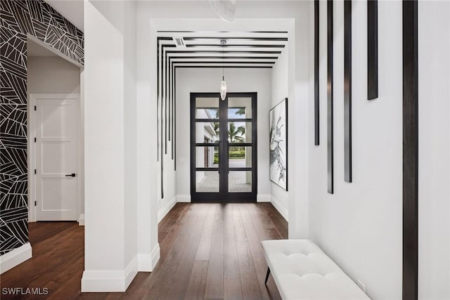 interior space with wood-type flooring, baseboards, and french doors