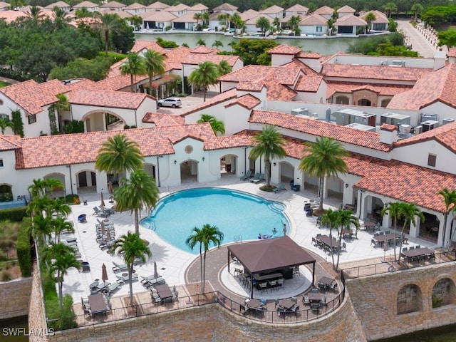 pool with a patio and a residential view