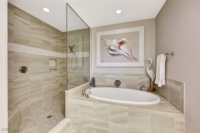 bathroom with a walk in shower, recessed lighting, and a bath