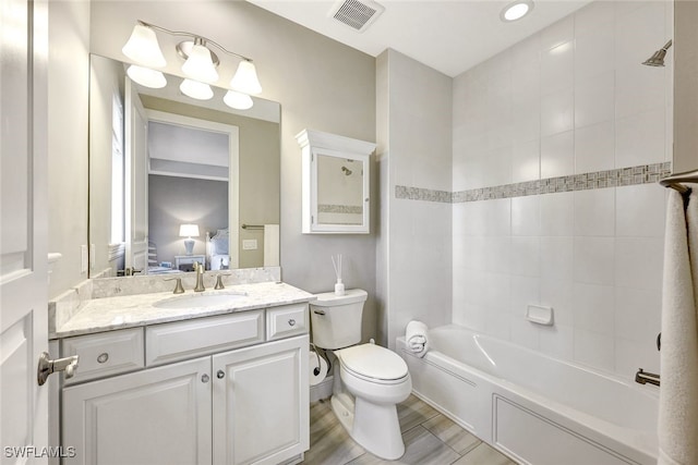 bathroom featuring connected bathroom, visible vents, toilet, shower / washtub combination, and vanity