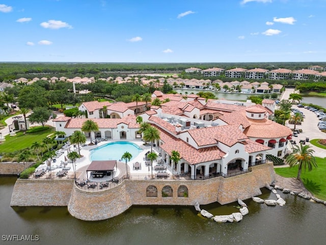 drone / aerial view with a water view and a residential view