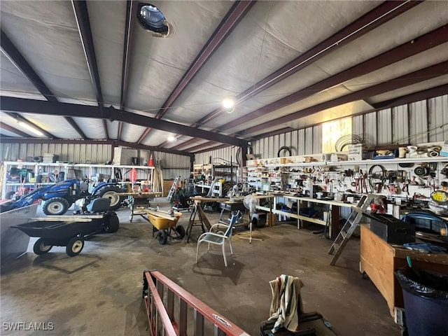 garage with a workshop area and metal wall