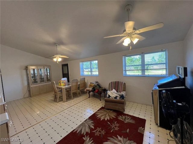 interior space with lofted ceiling, light floors, and ceiling fan