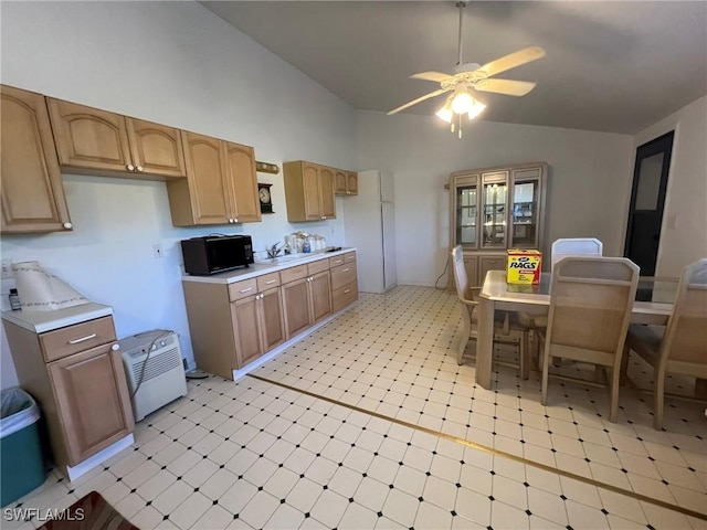 kitchen with ceiling fan, light countertops, light floors, black microwave, and a sink