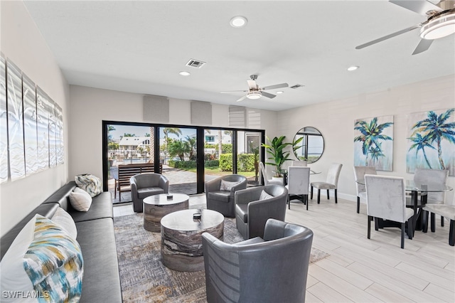 living room with ceiling fan, light wood-style floors, visible vents, and recessed lighting