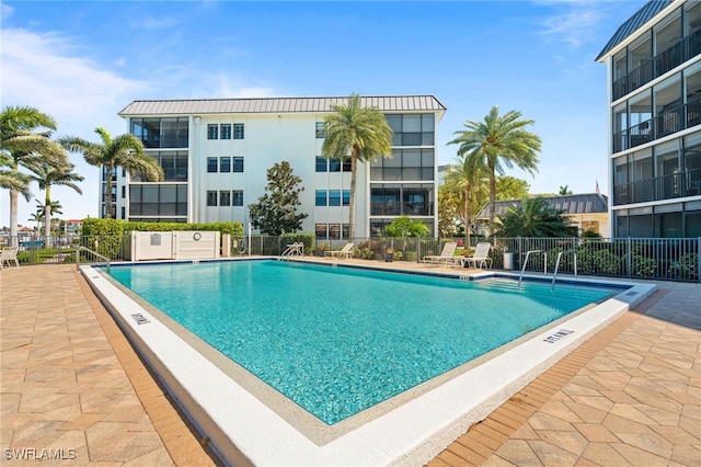 pool featuring a patio area and fence