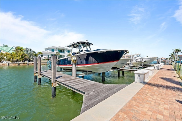 dock area with a water view and boat lift