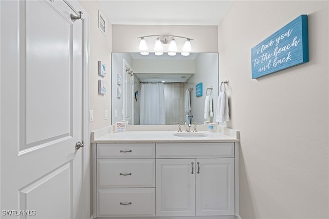 bathroom featuring visible vents, vanity, and a shower with shower curtain