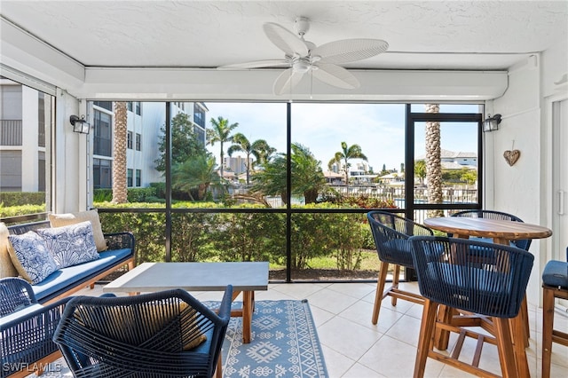 sunroom featuring a ceiling fan