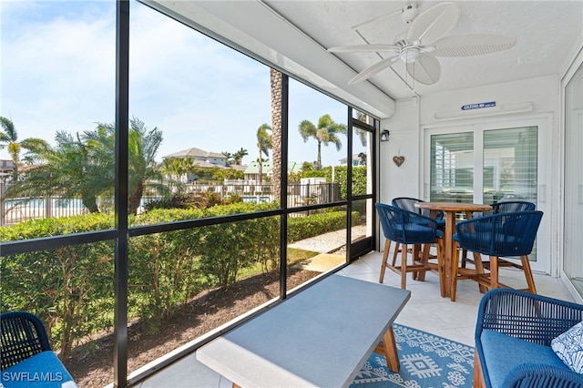 sunroom / solarium with ceiling fan