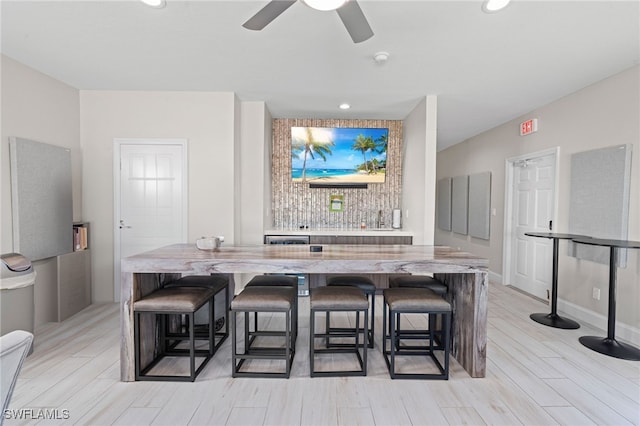 bar featuring a ceiling fan, wood tiled floor, baseboards, and recessed lighting