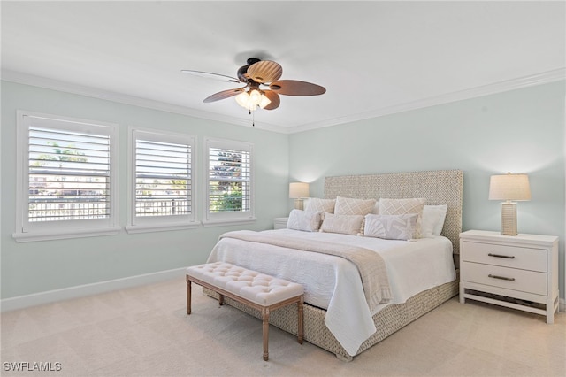 bedroom featuring light carpet, ceiling fan, baseboards, and crown molding