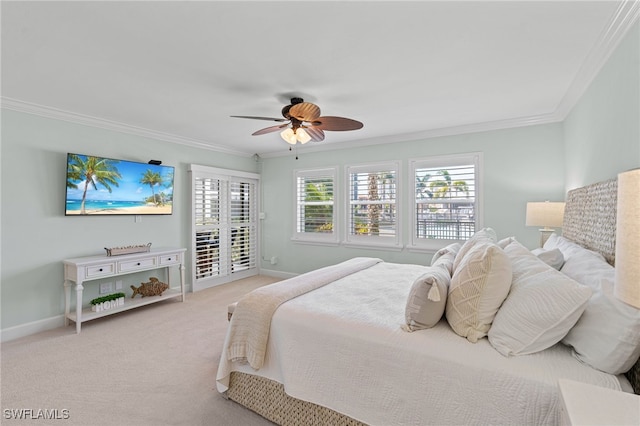 carpeted bedroom featuring access to exterior, a ceiling fan, baseboards, and crown molding