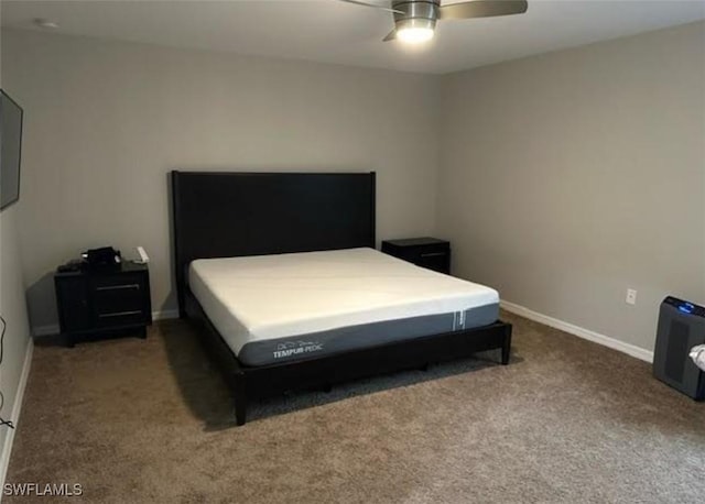 bedroom with a ceiling fan, carpet flooring, and baseboards