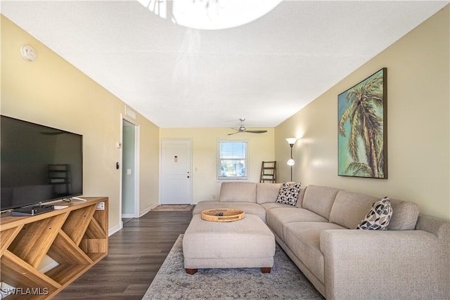 living room with a ceiling fan, dark wood finished floors, and baseboards