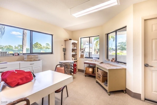 office space featuring light floors and baseboards