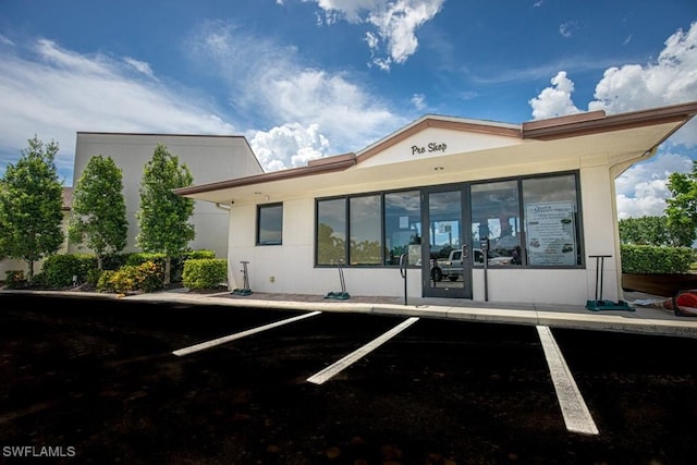 view of building exterior with uncovered parking