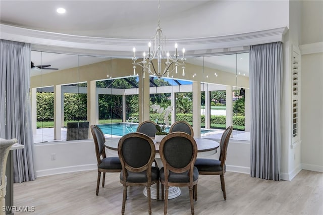 3311 Creekview Dr, Bonita Springs, FL 34134 - dining space featuring lofted ceiling, a chandelier, baseboards, and wood finished floors