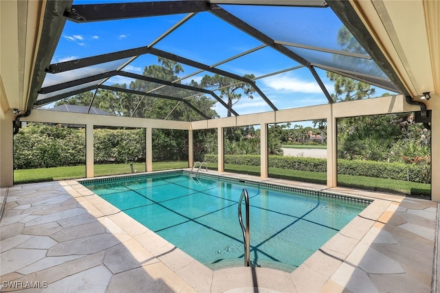 outdoor pool with a lanai and a patio area