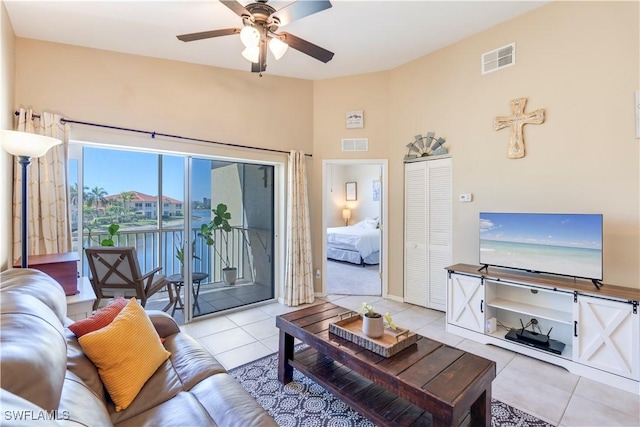 tiled living room featuring visible vents and a ceiling fan