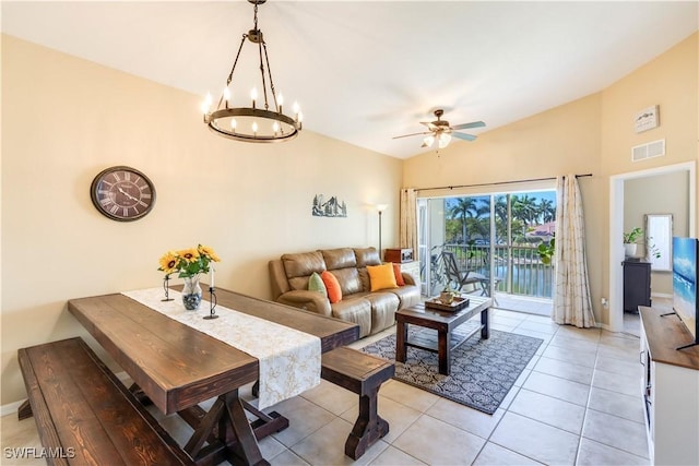 living room featuring visible vents, baseboards, light tile patterned flooring, lofted ceiling, and ceiling fan