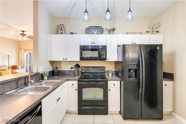 kitchen featuring a sink, decorative light fixtures, black appliances, and white cabinets