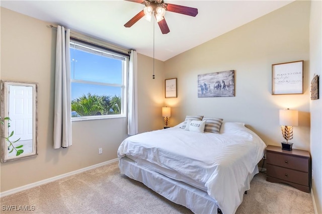 bedroom featuring a ceiling fan, lofted ceiling, carpet, and baseboards